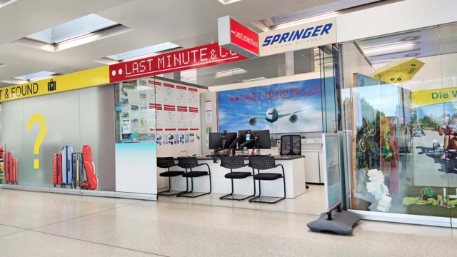 Front view of travel agency with desk and chairs
